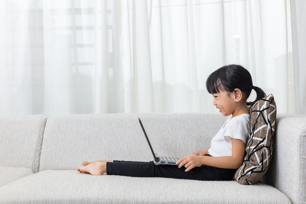 little girl using laptop